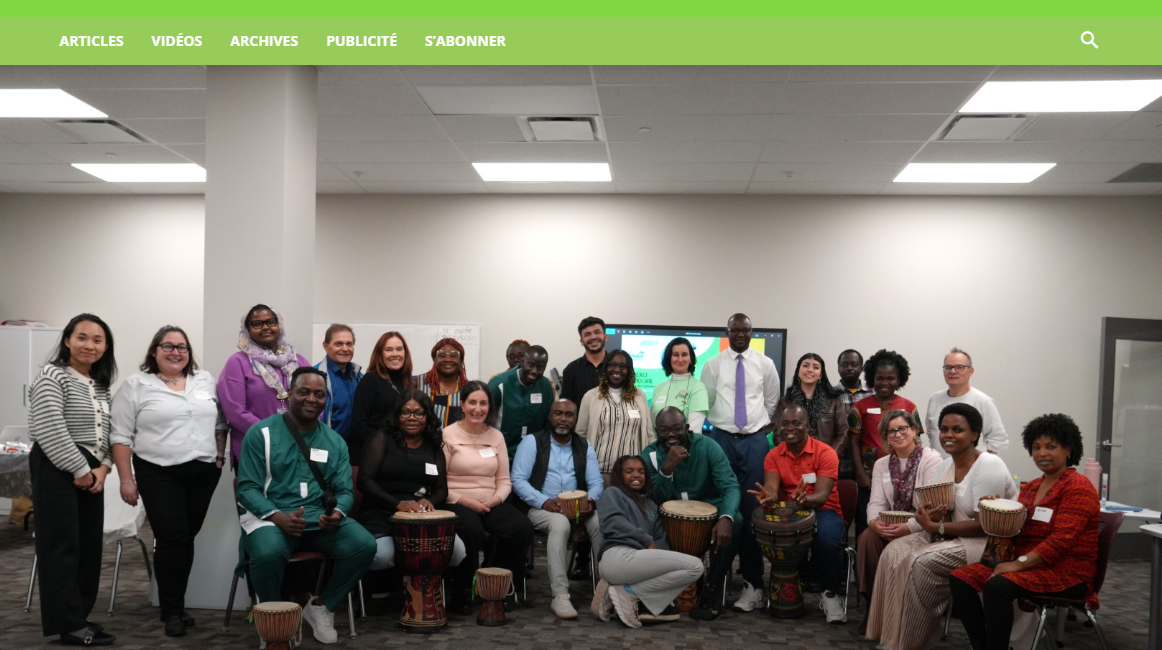 Photo de groupe prise lors d’une séance de réseautage pour les entrepreneurs francophones de London. Une trentaine de participants — entrepreneur·e·s, partenaires communautaires et membres de la CFA London — sont réunis dans une salle lumineuse, souriants et assis ou debout en rangs. Plusieurs personnes tiennent des djembés, soulignant la prestation du groupe de percussion DAX. L’ambiance est chaleureuse et conviviale.
